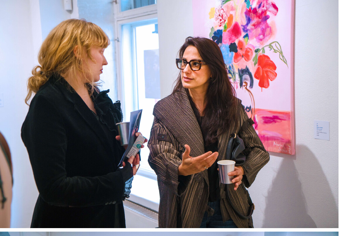 Farnaz Farahdel speaking with a visitor at Blue Verve Gallery